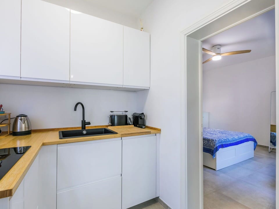 Flooring, Interior Design, Wood, Floor, Kitchen, Furniture, Room, Countertop, Cabinetry, Kitchen Appliance