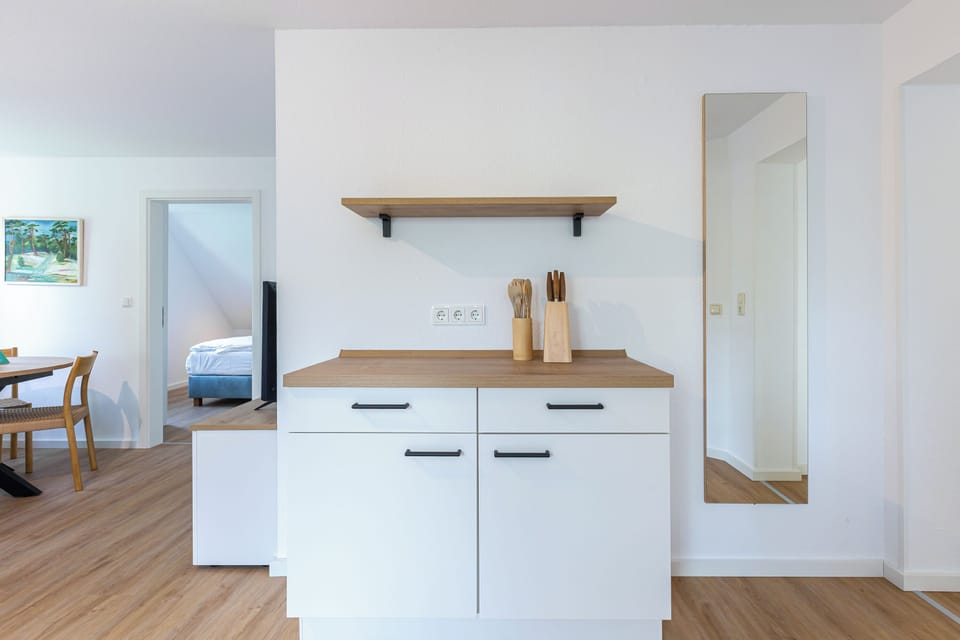 Modern Kitchen with Wooden Shelf and Cooking Utensils