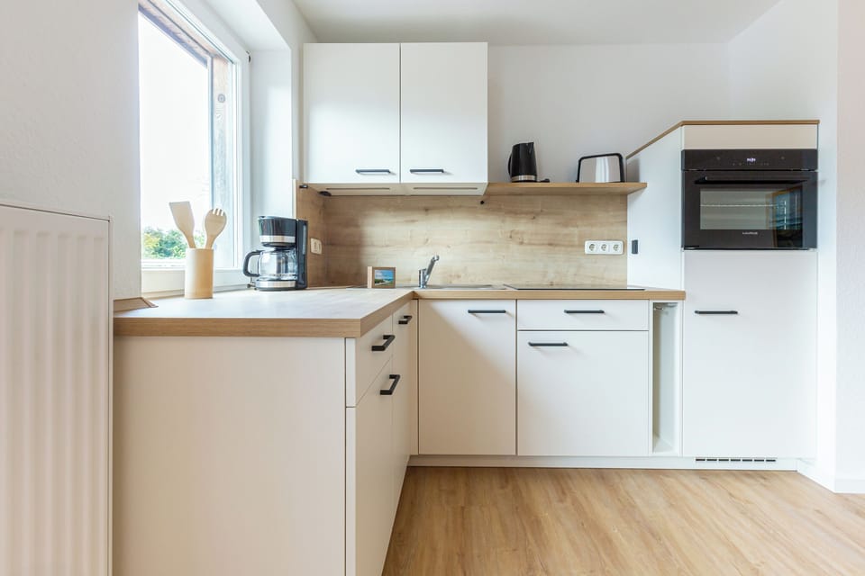 Modern kitchen with wooden surfaces and appliances.