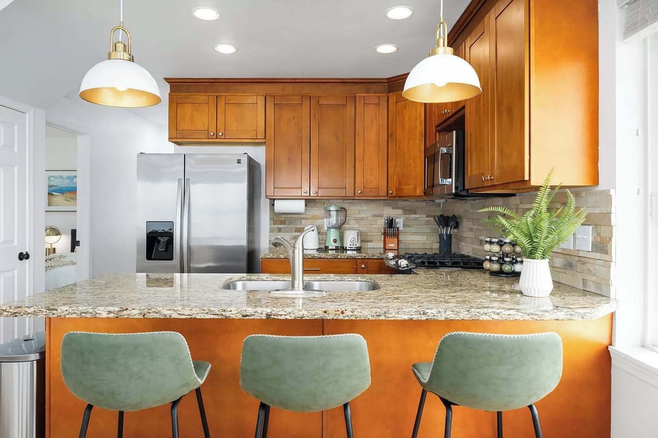 The kitchen boasts a modern design with stainless steel appliances, granite countertops, and a view that makes cooking a delight.