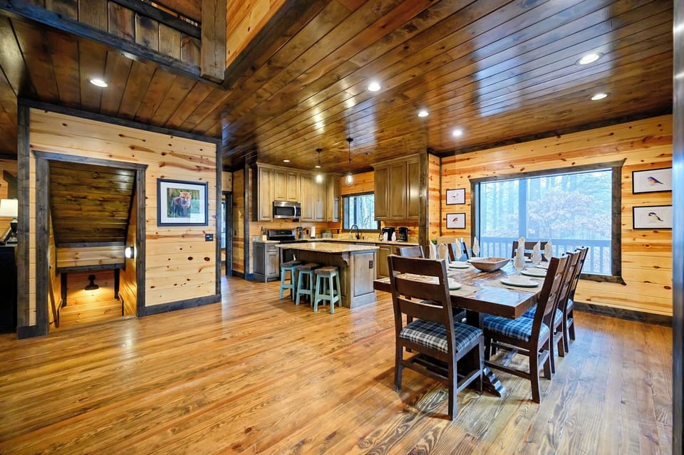 Open concept kitchen and dining room. Stair access for bottom floor with game room and bunk room