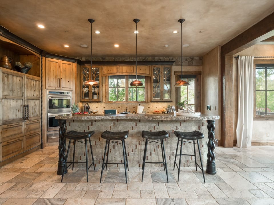 Entertainer's Kitchen – An expansive culinary stage with oversized island, premium appliances, and open seating—ideal for entertaining, catering, and family gatherings.