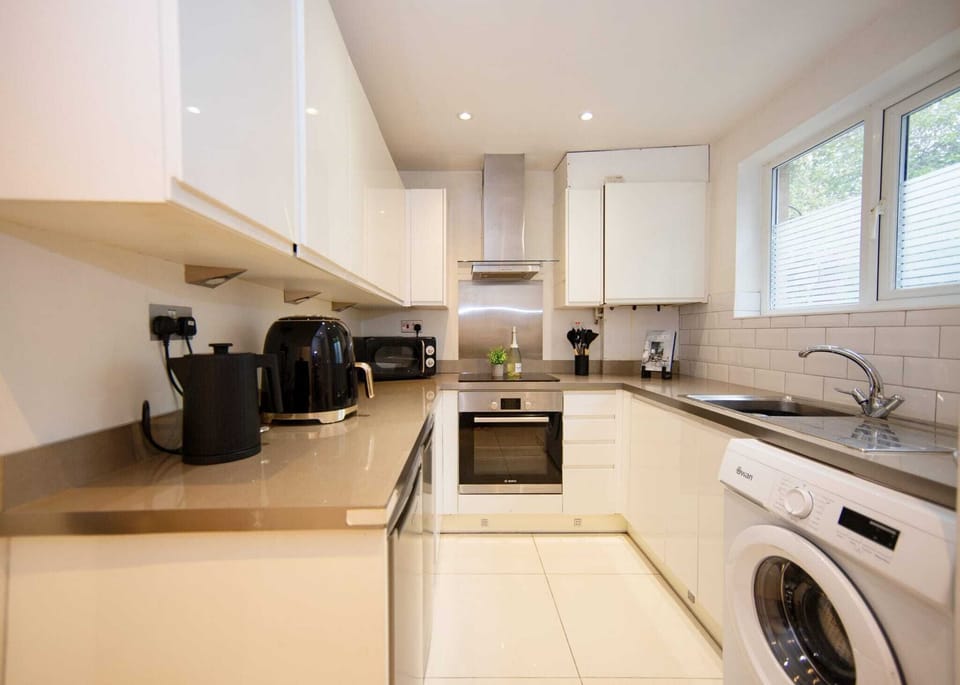 Kitchen With Stove Hob Microwave Oven Kettle Toaster And Essentials. 