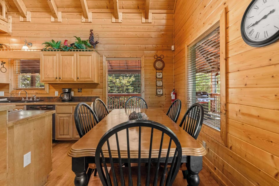 Spacious dining area with rustic wood table, perfect for family meals.
