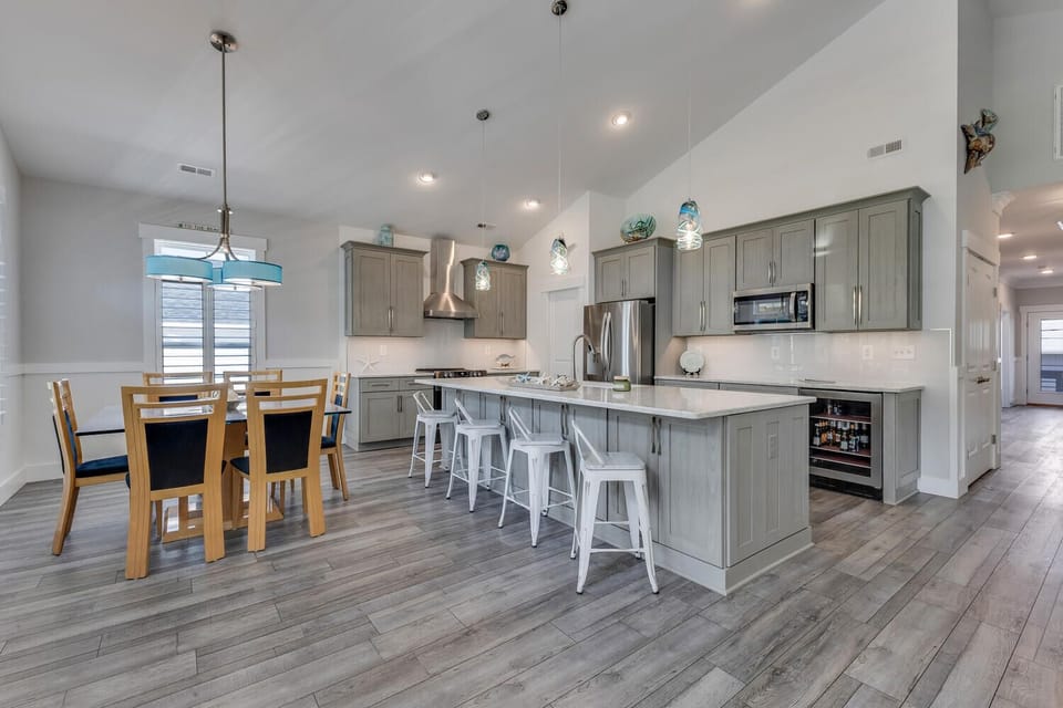 Cook together in your spacious gourmet kitchen featuring modern appliances, a large island for gathering, and open dining space perfect for memorable meals.