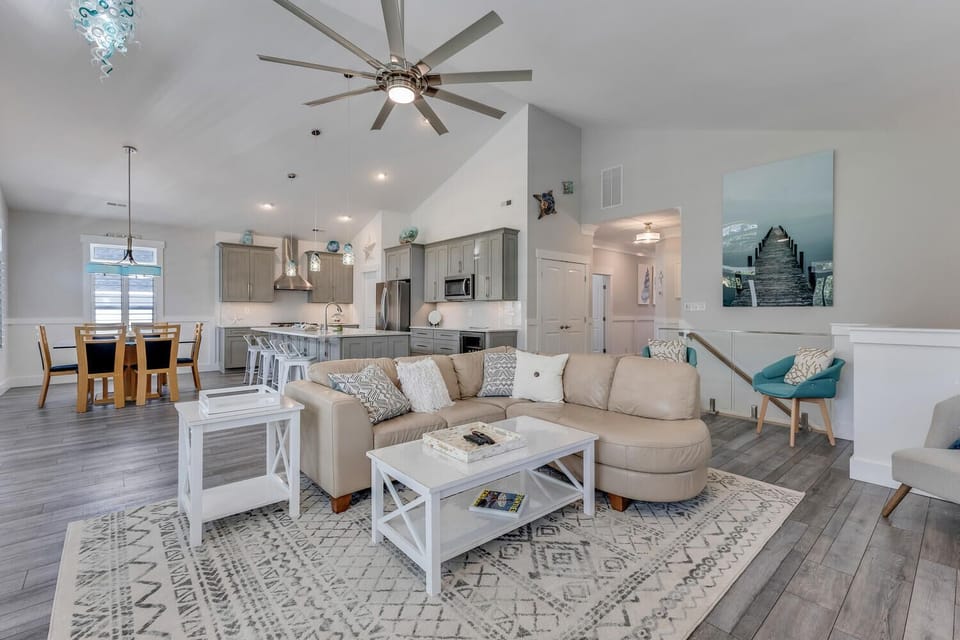 Unwind in your open-concept living space with soaring ceilings, stylish furnishings, and a fully equipped kitchen perfect for creating memorable meals.