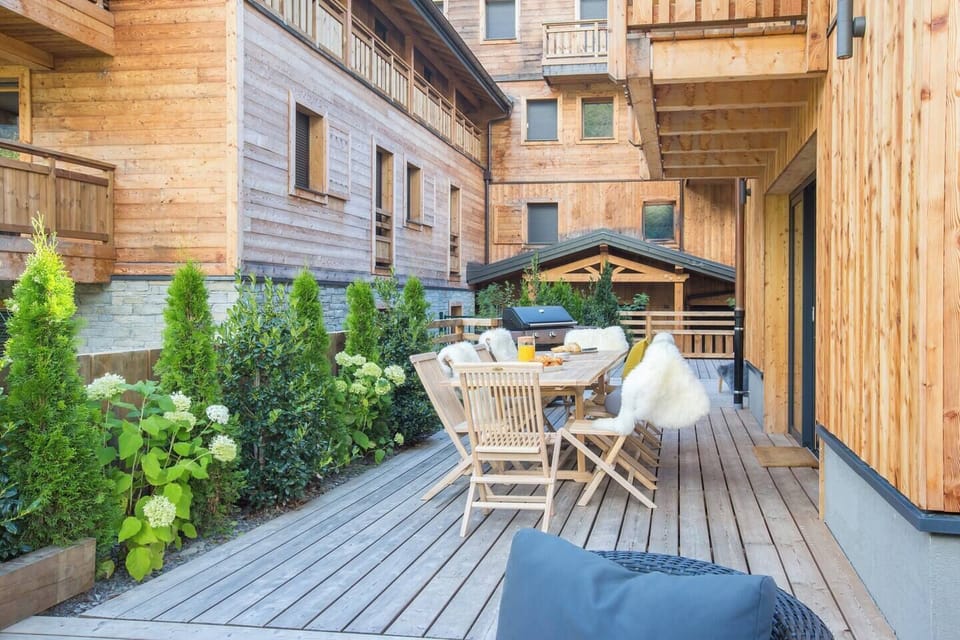 Decking area at the back of the chalet with BBQ in summer