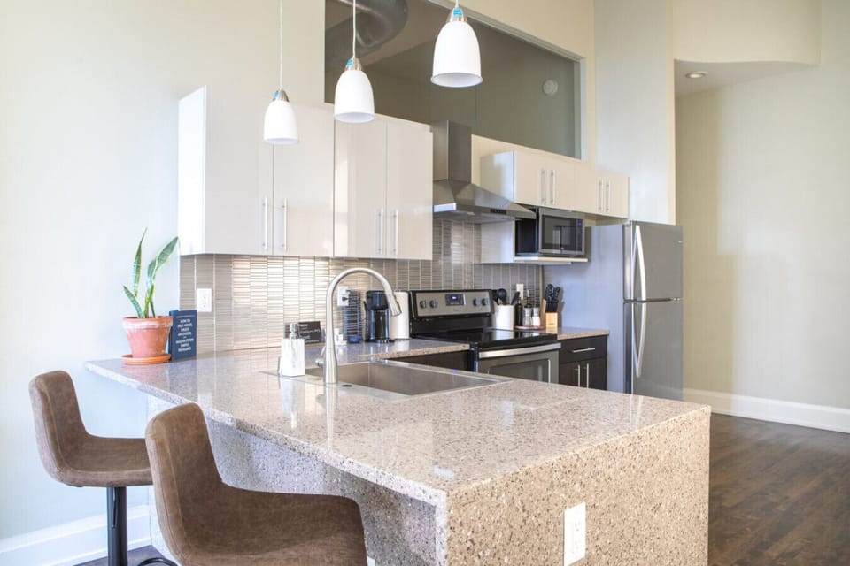 Full kitchen with bar stool seating and dining table
