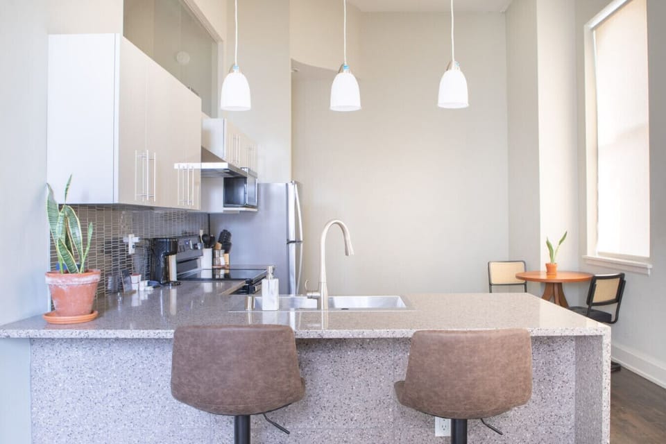 Full kitchen with bar stool seating and dining table