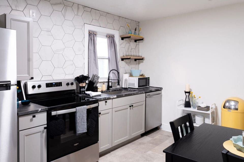 A fun, simple kitchen sits in the back of the house with all you need to cook or reheat a meal.