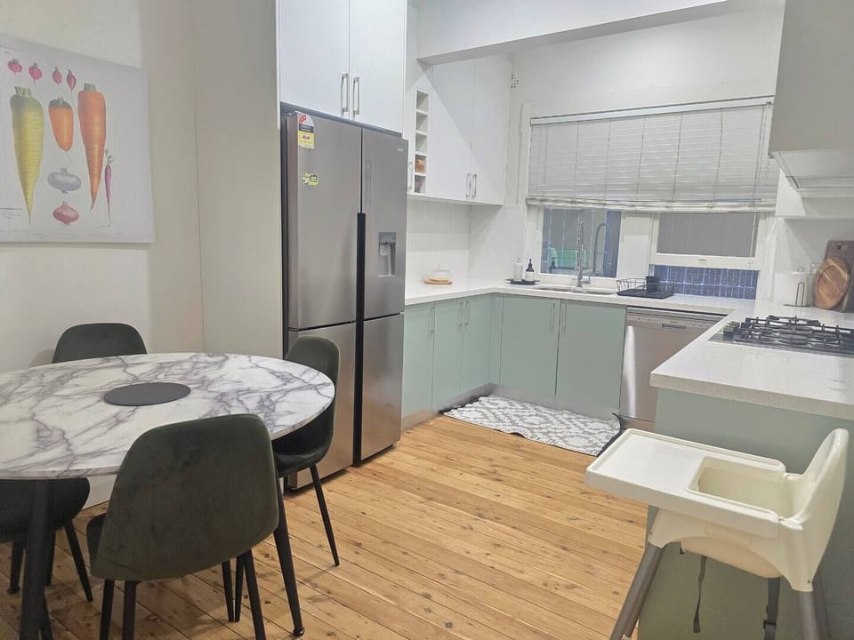 Full kitchen with gas cooktop, oven, full-sized fridge and dining table for 4. Stylish and well equipped for longer stays.