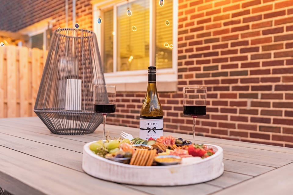 Relax on the patio with wine, a charcuterie board, and cozy string lights.