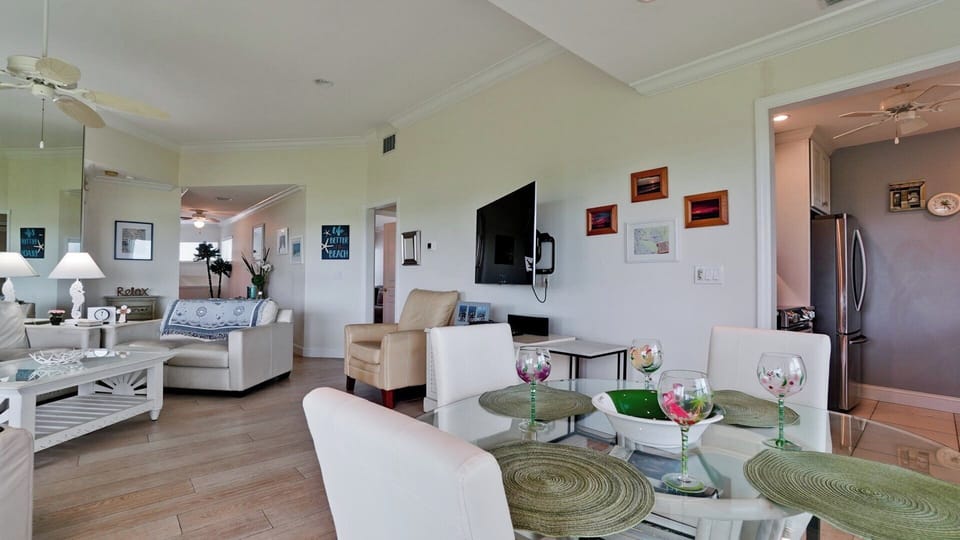 Dining area to living room and hallway to stairs