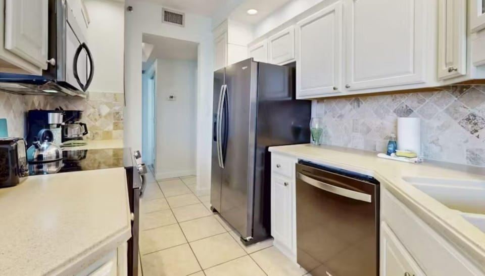 Spacious kitchen with stainless steel appliances and ample storage