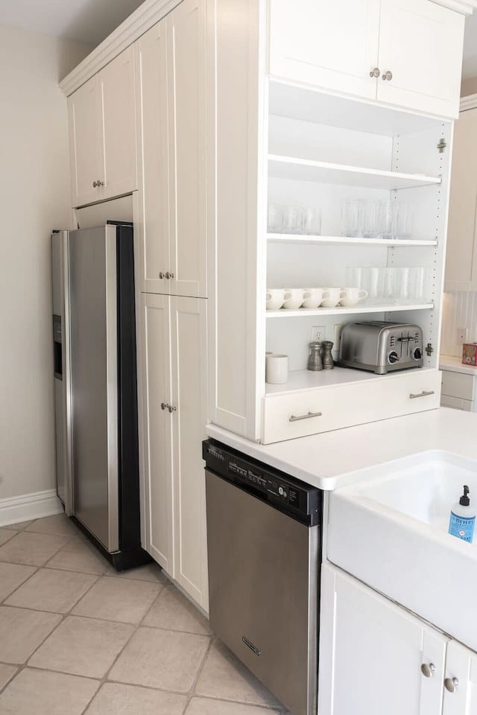 Refrigerator and freezer with ice maker, dishwasher and farmhouse sink.