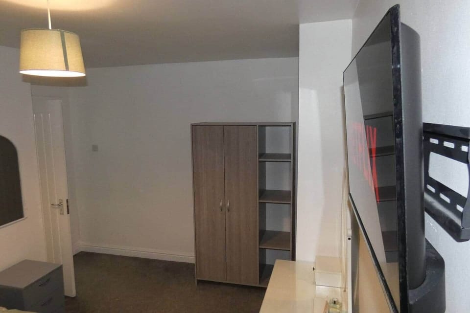 Master bedroom featuring double bed, dressing area, double wardrobe, and towels/blankets provided.