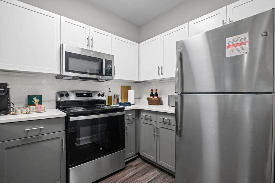 Fully stocked kitchen — stainless fridge, stove, microwave, dishwasher & more