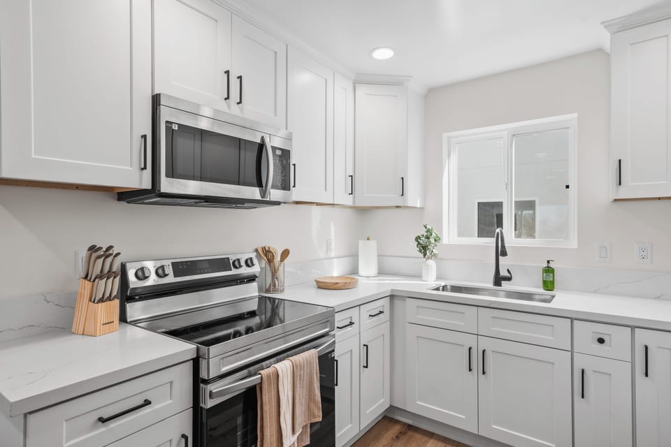 Fully equipped kitchen with stainless steel appliances.