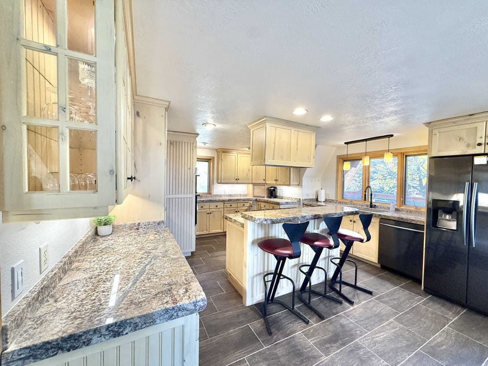 The elegant yet rustic kitchen will be sure to charm you with bar seating and premium finishes.