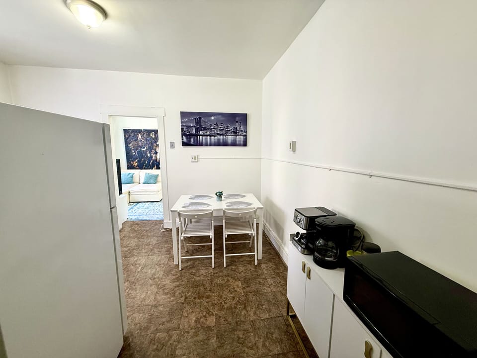 Bright kitchenette with dining for four, coffee & air-fryer, near cozy lounge