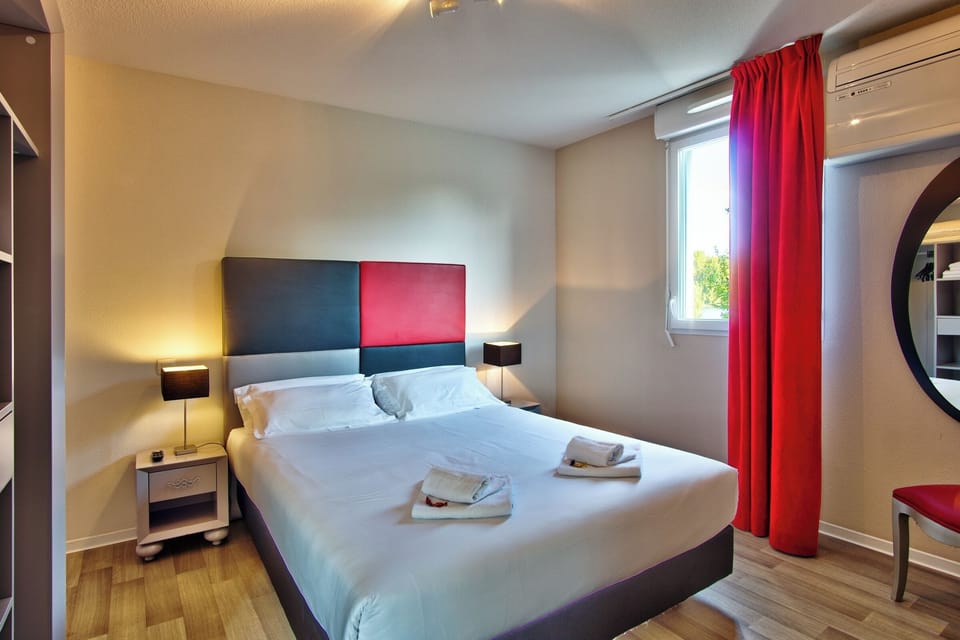 Wake refreshed beside red curtains and a serene window view.
