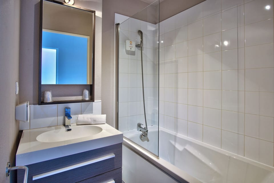 Refresh with a deep soak and spotless modern vanity.