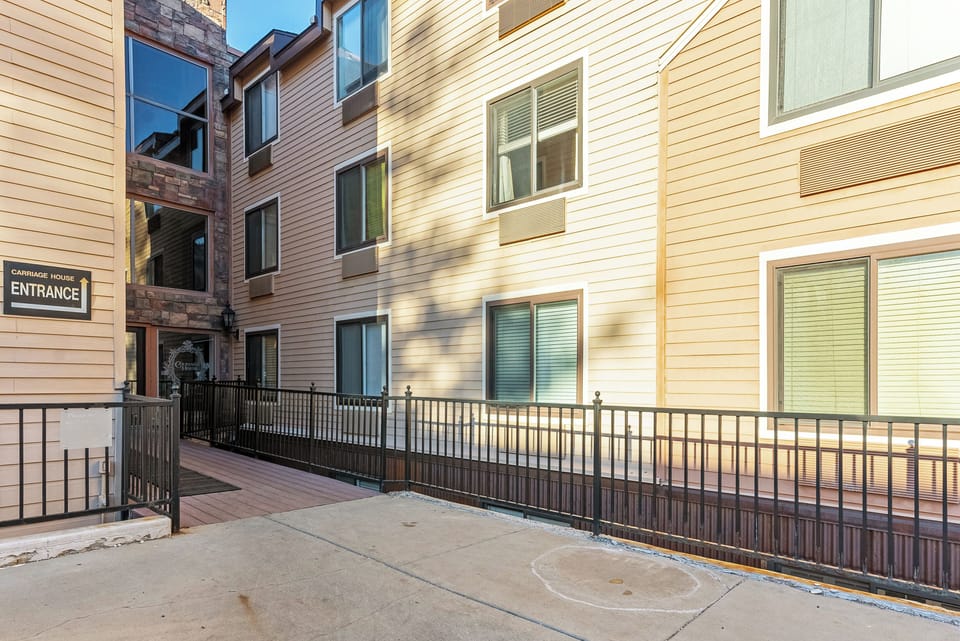 Exterior view of the building featuring a modern design and secure gated access.