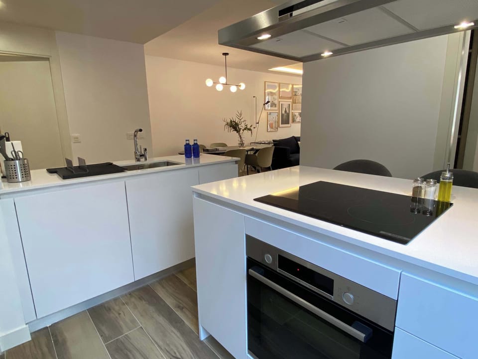 Modern kitchen fully equipped with appliances.