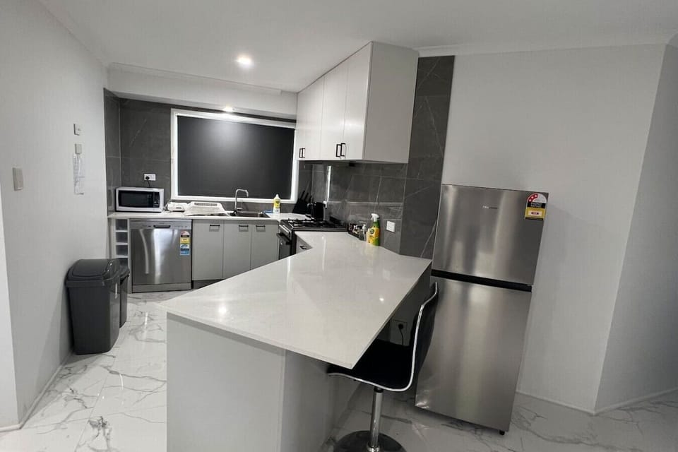 Full kitchen with dishwasher and fridge