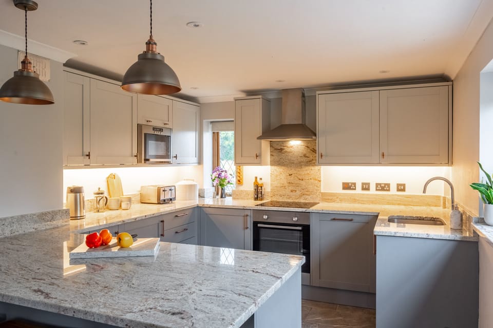 Ground floor: Kitchen with electric oven and hob, dishwasher and fridge with icebox, microwave, wine fridge, washing machine and sit up island with three stools