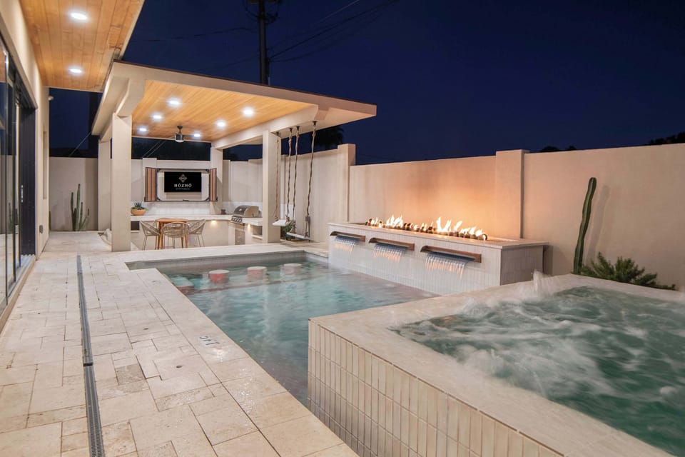 Enjoy evenings by the pool, hot tub, and fire feature in your private backyard oasis.
