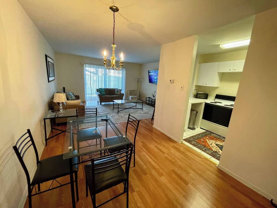 The living room comes furnished with essential pieces, including a comfortable sofa, a coffee table, and a TV stand, providing immediate comfort upon move-in.