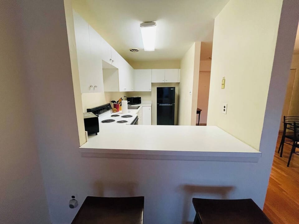 Step into a well-appointed kitchen designed for convenience. It includes a full-sized refrigerator, range, and plenty of counter space for meal prep. You'll find generous storage in the cabinetry, making it easy to keep things organized.