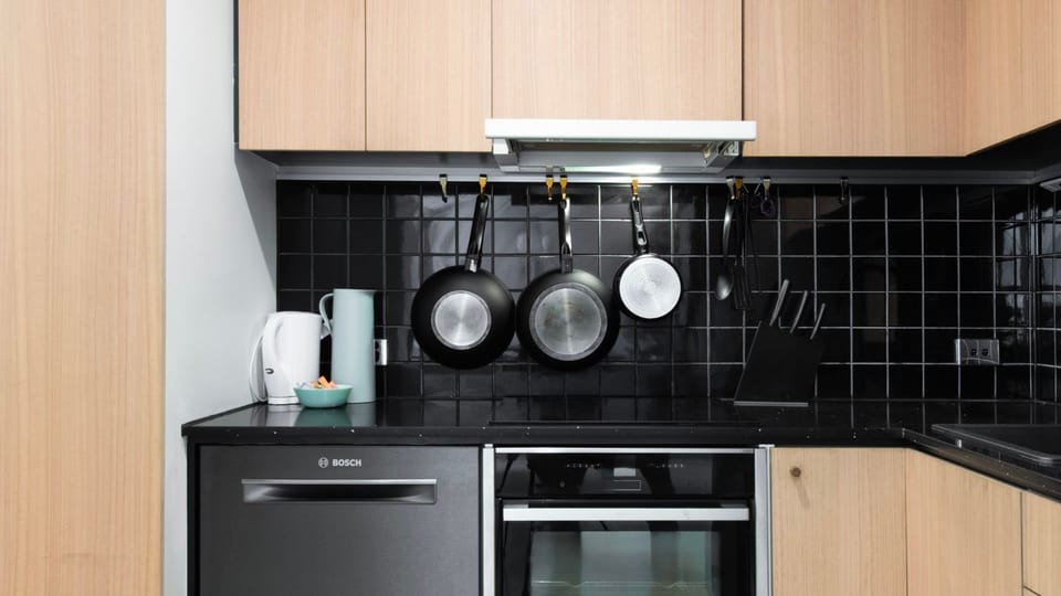 Fully equipped kitchen featuring stovetop, oven, and sleek finishes.