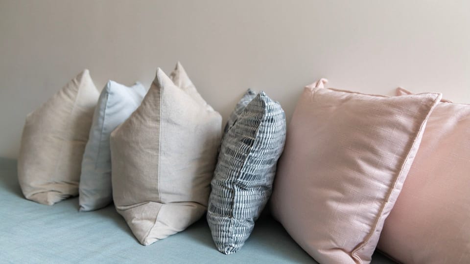Soft accent pillows add a touch of comfort and colour to the seating area.