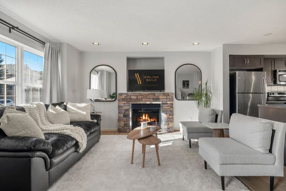 Main floor living room with a gas-lit fireplace, 50` Smart TV, and luxurious seating options to kick back on after a day of adventures.