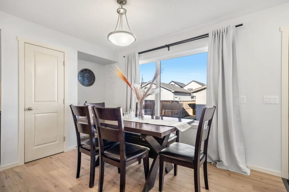 Dining area with seating for 6 at the table and 3 at the island.