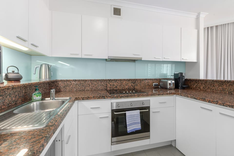 Prepare home-style dishes in the modern kitchen with a full oven, stovetop, dishwasher, and Nespresso machine for effortless convenience.