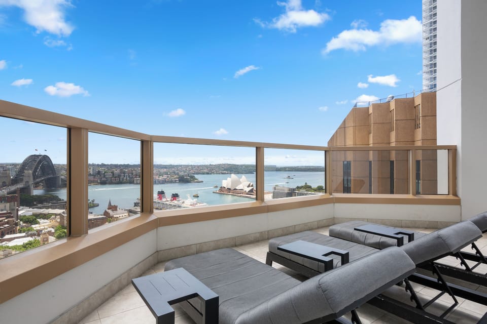 Gaze across Sydney Harbour from the shared rooftop haven, where sweeping views of the Bridge, Opera House, and passing cruise ships create a breathtaking backdrop to your stay.