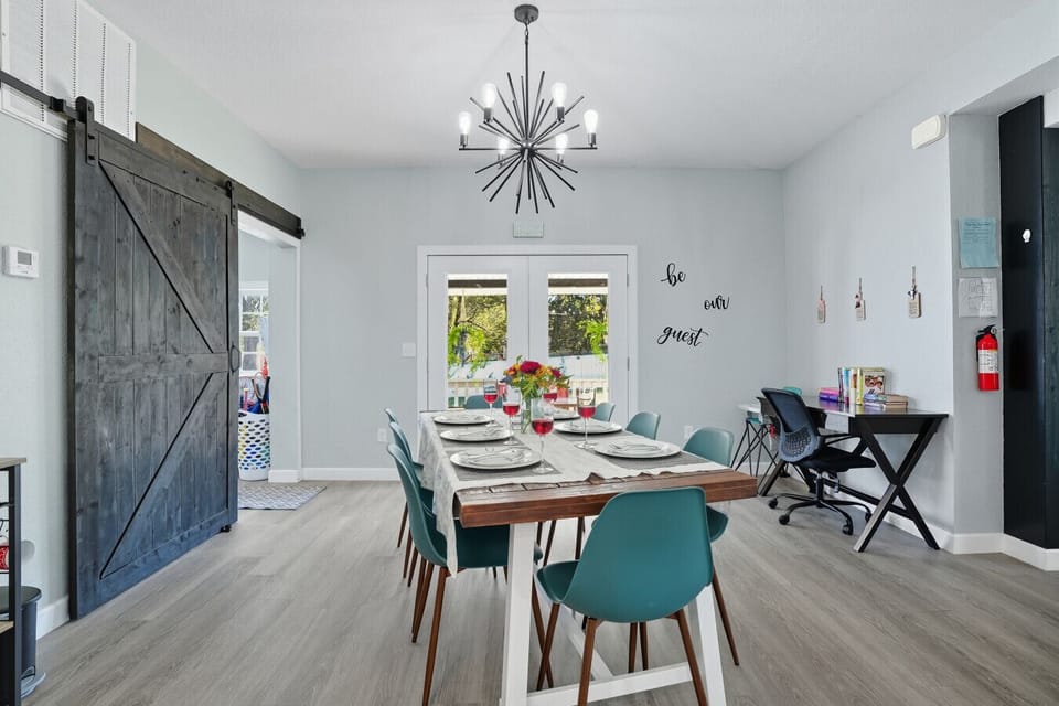 Modern Dining Room | Farmhouse Table with Contemporary Lighting | Cozy Space with Coffee Bar & Patio Access
