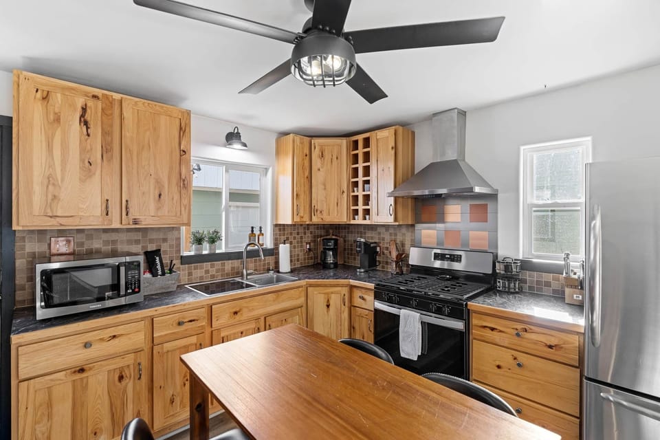 Kitchen: Whip up culinary delights in a stylish space with sleek appliances and natural wood charm!