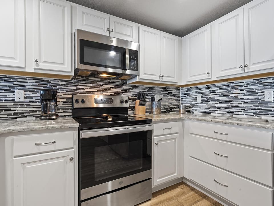 Modern kitchen with sleek appliances and stylish backsplash