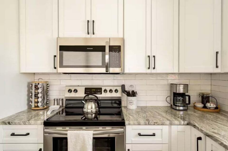 Make yourself at home in this kitchen! There is an electric stove and other amenities like a coffee maker and water kettle.