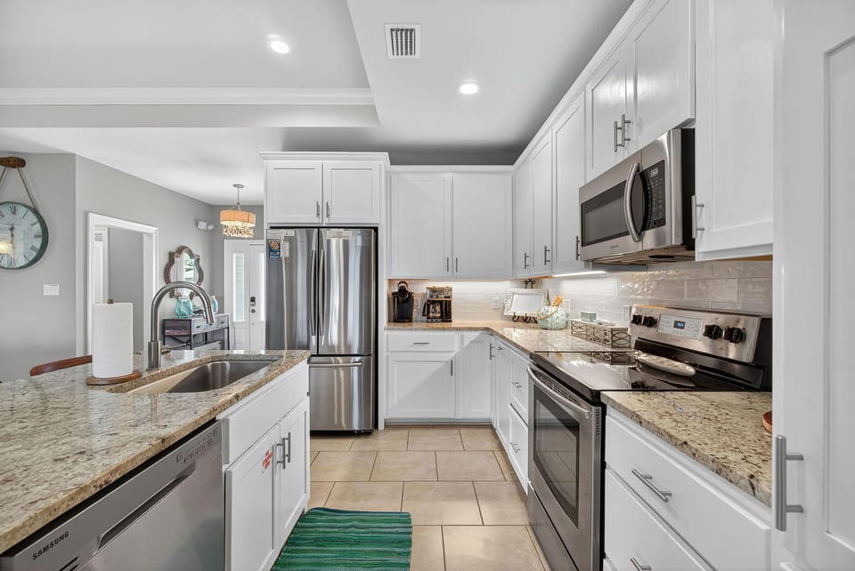 This thoughtfully designed kitchen features a large eat-in island perfect for casual breakfasts, meal prep, or gathering with friends.