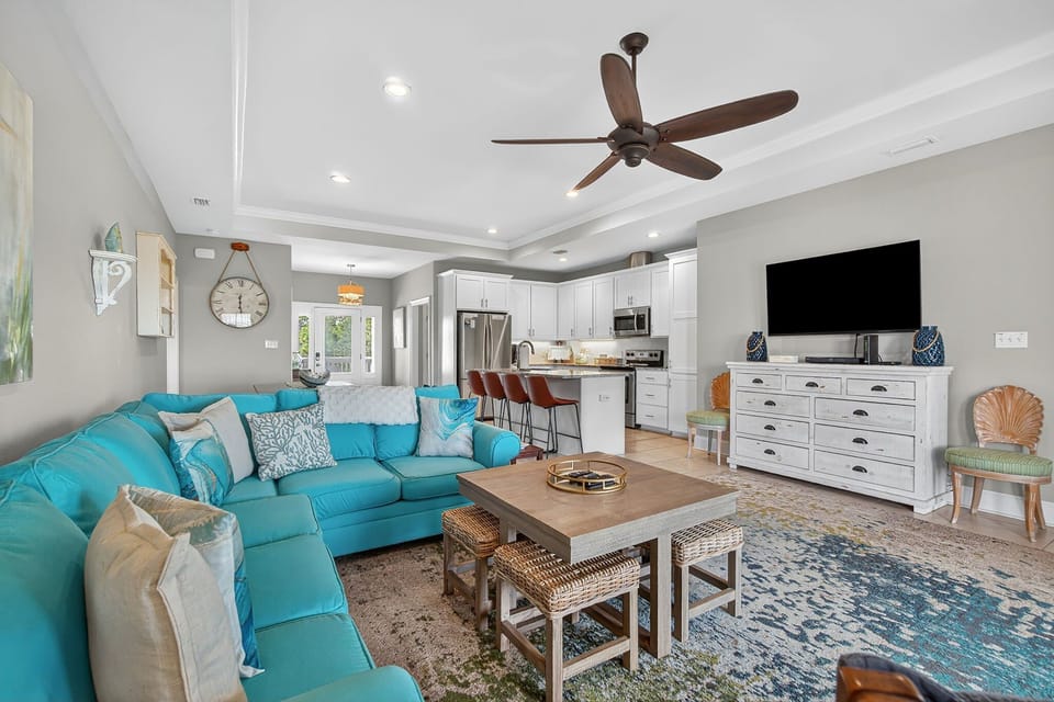 The living room is a welcoming hub designed for relaxation and connection. With an open floor plan that flows seamlessly into the dining area and kitchen