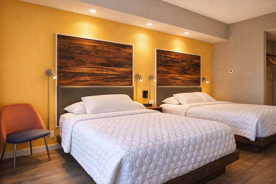 Settle into plush beds under warm lights for restful nights.