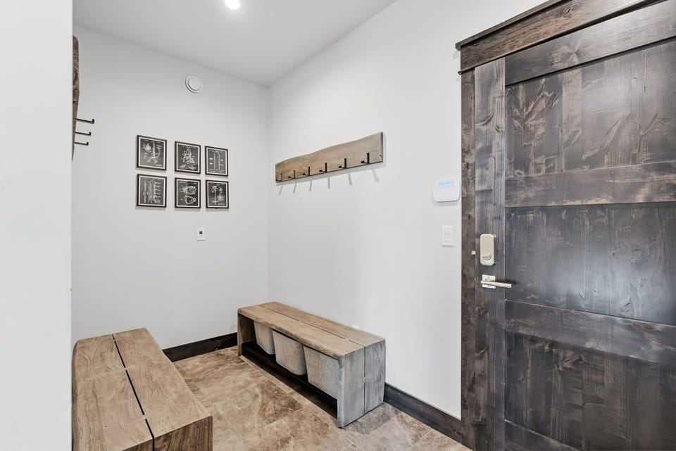 Entryway: Mudroom with hooks, bench seating, storage bins, and digital lock access