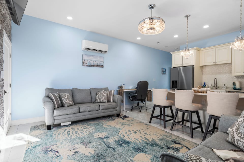 Open-plan layout connecting the living area, workspace, and kitchen space.