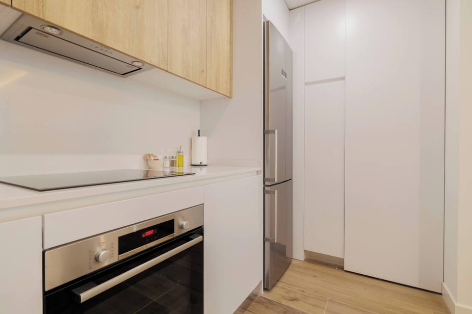 White kitchen with integrated appliances.