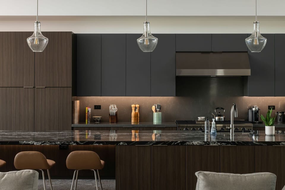 A closer look at the gourmet kitchen, highlighting the gas range, custom cabinetry, and premium stone countertops.
